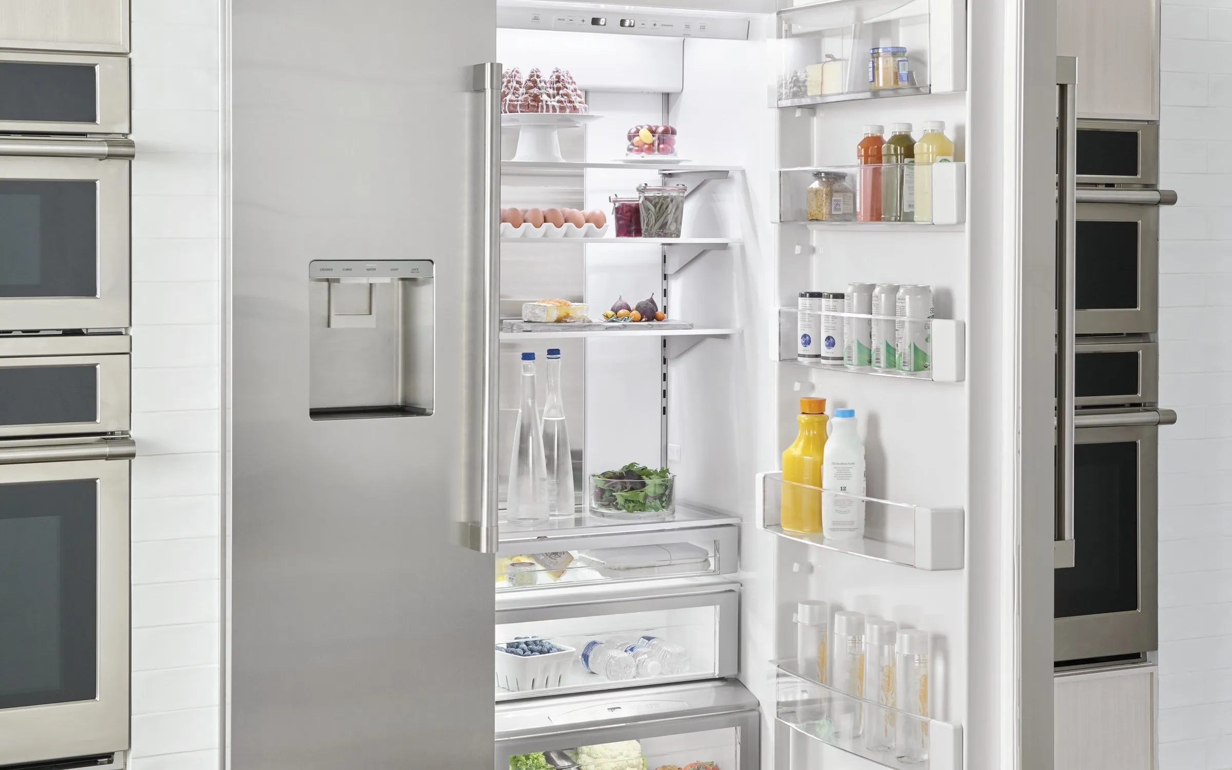 Monogram Statement built-in refrigerator in a luxury kitchen with cookware on display