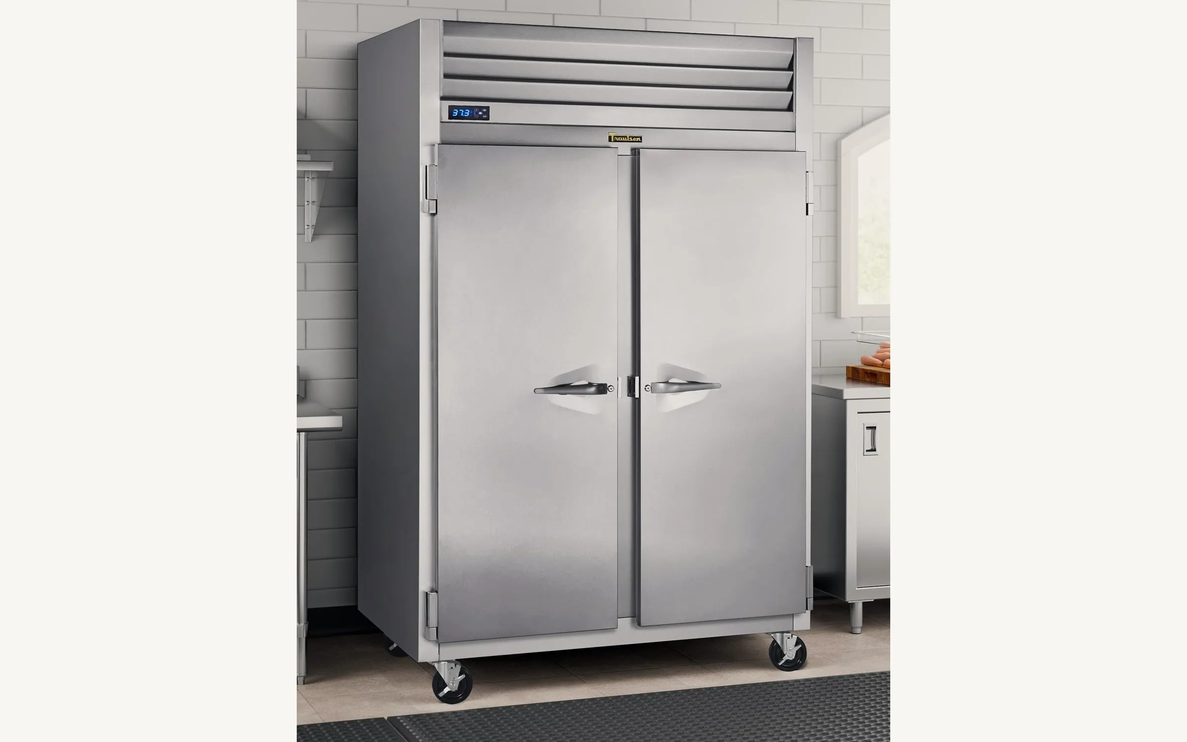 Traulsen G-Series RIH commercial reach-in with evaporator fan motor exposed at Costa Mesa restaurant kitchen